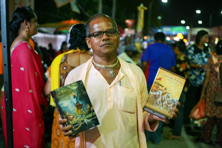 A man selling Vedas, a Hindu religious text at the entrance of the Batu Caves Temple during the Thaipusam festival on February 03, 2015. The Hindu festival of Thaipusam, commemorates the day when Goddess Parvati gave Lord Murugan a Vel, a divine javelin to destroy the evil demon Soorapadman. photo Aizzat Nordin