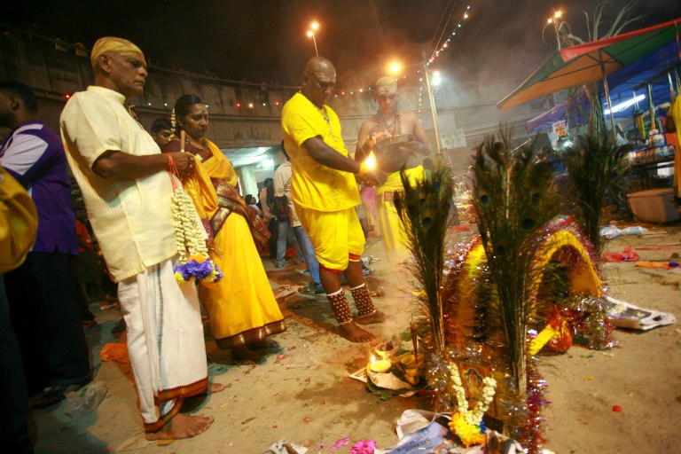 Ramachandran.55 (L) and his family are praying after performing the religious bath outside of the the Batu Caves Temple during the Thaipusam festival on February 03, 2015. The Hindu festival of Thaipusam, commemorates the day when Goddess Parvati gave Lord Murugan a Vel, a divine javelin to destroy the evil demon Soorapadman. photo Aizzat Nordin