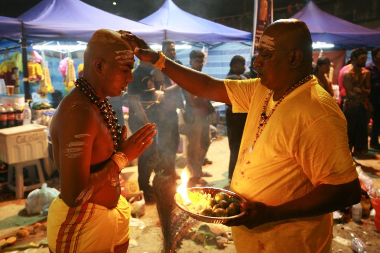 Siva Kumar,20 (L) getting a blessing from his uncle, R. Megavarnam, 50 (R) before getting his kavadi outside of the Batu Caves Temple during the Thaipusam festival on February 03, 2015. The Hindu festival of Thaipusam, commemorates the day when Goddess Parvati gave Lord Murugan a Vel, a divine javelin to destroy the evil demon Soorapadman. photo Aizzat Nordin